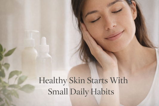 Woman with glowing skin beside skincare products representing healthy skin built through small daily skincare habits.