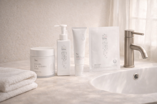 Minimal skincare setup in a calm bathroom environment with soft lighting and neutral tones, representing a relaxing skincare routine