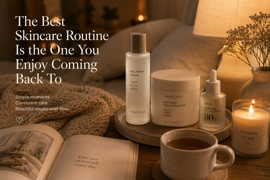 Minimal Korean skincare products beside a candle, book, and ceramic cup in a warm, cozy home setting representing a relaxing daily skincare ritual.